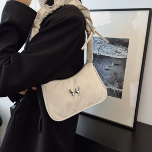 Chic cream-white underarm bag with silver butterfly buckle and pleated ruffle shoulder strap