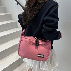 Pink nylon tote bag large capacity crossbody bag shown with a lifestyle outfit and white stairs