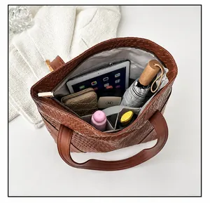 Interior view of large capacity woven tote bag showing daily essentials and pockets