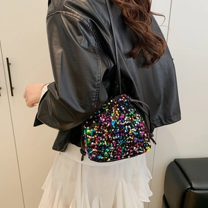 Colorful sequin drawstring bucket bag with black strap shown on a fashion model