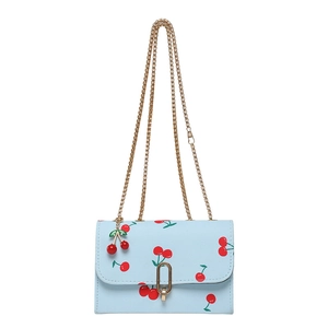 Light blue crossbody bag with cherry print, golden chain strap and cherry pendant charm