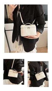 Detail view of cream mini handbag with pebble grain leather and silver hardware zipper