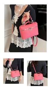 Pink lychee grain leather crossbody bag with top handle and dual metal zipper detail
