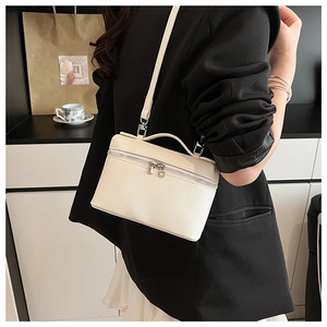 Detail of cream lychee texture leather crossbody bag with silver double metal zippers