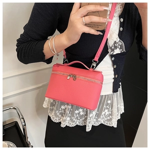 Pink lychee grain leather handbag with silver zipper shown in a mirror selfie