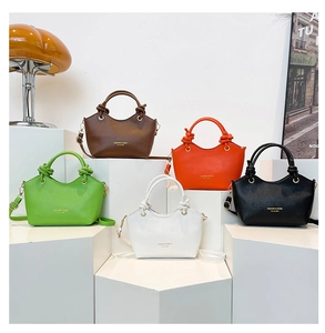 Group display of five colorful litchi leather bucket bags with unique knot handles