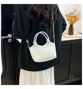 Detailed back view of white lychee pattern leather tote with knot handle and strap