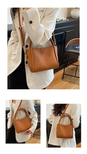 Detail of caramel leather tote bag showing lychee grain texture and V&B brand engraving