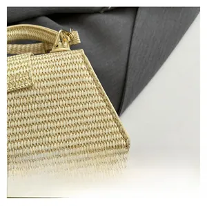 Detail of beige straw weave texture and gold metal buckle on a retro shoulder bag