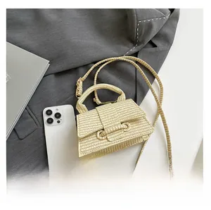 Close-up of a cream woven mini bag with textured flap and crossbody strap details
