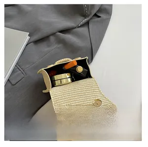Detail of straw woven mini bag showing interior space for lipstick and compact