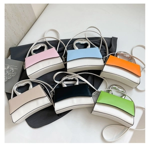 Detail view of stylish square crossbody bags with unique silver heart-shaped metal handles