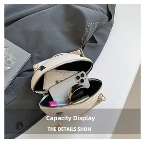 Detail view of the cream round bag's interior capacity showing daily essentials