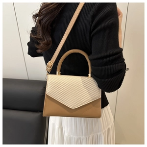 Brown and beige shoulder bag with woven texture lid and golden hardware details