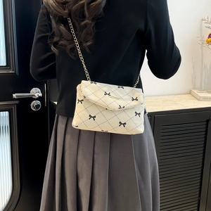 Chic corduroy crossbody bag with floral bow print and golden metal chain strap