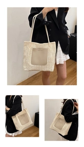 Detail of woven straw tote bag featuring a leather pocket with FASHION & BAGS text
