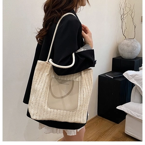 Detail of woven tote bag with PU leather pocket and white rope handles for summer