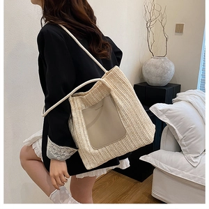 Detail of bohemian woven tote bag with beige straw texture and leather pocket