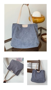 Detail of blue corduroy tote bag with leather handles and fashion label detail