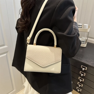 Elegant beige crossbody small square bag with textured flap and top handle for women