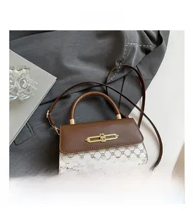 Detailed view of vintage crossbody bag with brown leather and retro monogram pattern