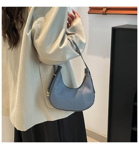 Blaue Hobo-Tasche mit Webstruktur an der Schulter für Stil- und Größenreferenz