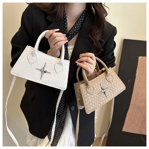 Detail showing white and khaki mini crossbody bags with star-shaped metal buckle on the front