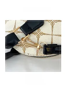 Detail of golden metal lobster clasp and D-ring on white pebble leather bag strap