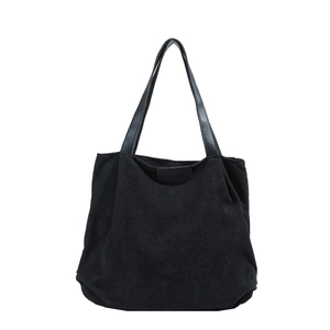 Black corduroy tote bag with leather straps and Fashion text in a minimalist style