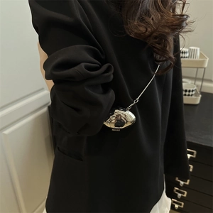 Mini silver shell-shaped metal crossbody bag with a sleek chain strap for women