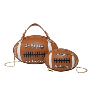 Rugby shaped brown crossbody bags with metal chain strap and white stitch details
