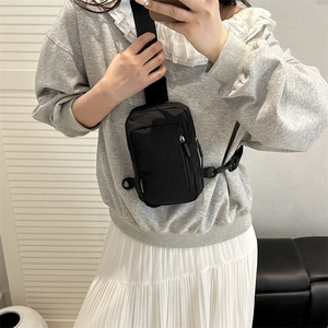 Minimalist black nylon crossbody phone bag for women with adjustable strap and front pocket