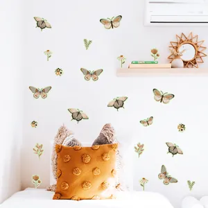 Detailed view of luminous green Bohemian butterfly and floral wall stickers in bedroom decor