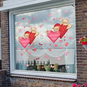 Detailed view of Valentine's Day cartoon bears and LOVE stickers on glass window glass