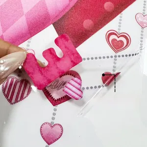 Detail showing flexible double-sided love heart window sticker with pink patterns