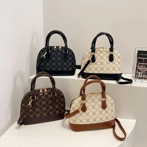 Classic shell-shaped bowling bags in four colors with geometric patterns and gold zippers