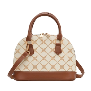 Retro beige shell crossbody bag with brown leather handles and geometric letter pattern
