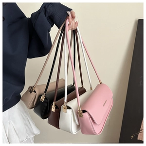 Close-up of stylish faux leather baguette bags in five colors with golden hardware details