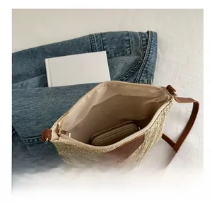 Interior view showing the large capacity and brown lining of the straw woven crossbody bag