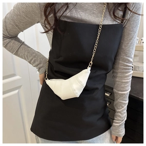 Detail view of mini white croissant bag with pleated design and gold metal chain