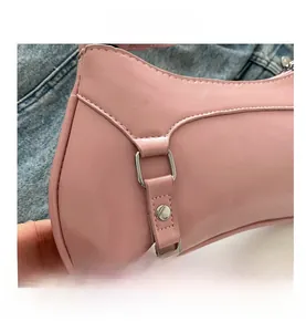 Close-up of pink minimalist baguette bag with silver metal buckle and stitch detail