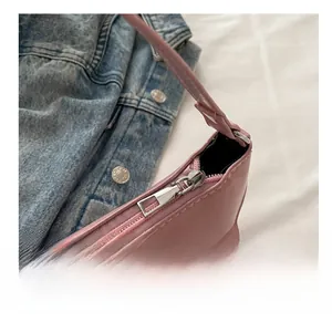 Detail of pink faux leather bag showing smooth metal zipper and fine stitching craftsmanship