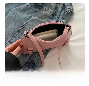 Interior view of pink baguette bag showing storage capacity for phone and wallet