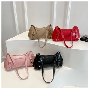 Four elegant baguette shoulder bags in khaki red pink and black on a white display stand