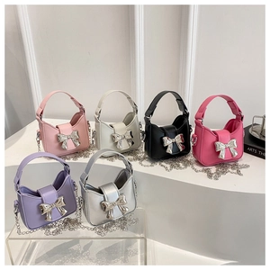 Mini crossbody bags with silver bow accents and metal chains in six vibrant colors