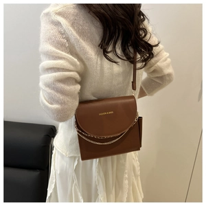 Brown leather crossbody bag featuring gold chain detail and Fashion & Bags inscription