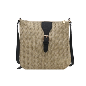 Straw bucket bag with black leather strap and gold hardware for summer beach vacations