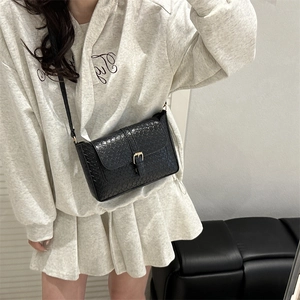 Chic black woven PU leather shoulder bag with gold clasp shown on a model outfit