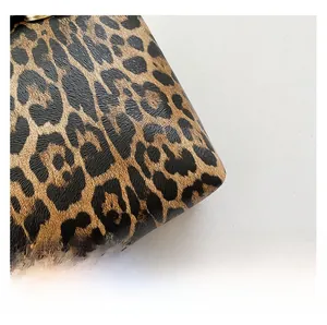 Detailed macro view of the premium leopard print leather texture on a stylish handbag