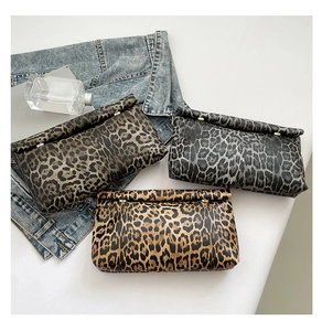 Vista dettagliata di tre pochette leopardate in marrone grigio e beige con dettagli dorati